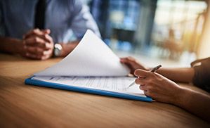 A person signing documents. 