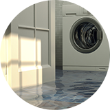 Standing water in front of a washer.