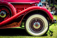 Close-up of wheel on a red vintage car.