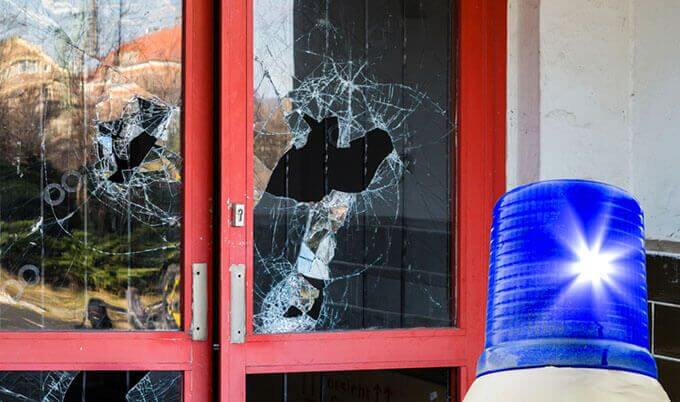 A broken windows on a business door.