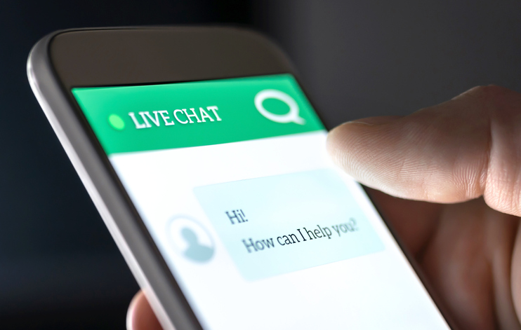 A live chat screen on a smartphone, with a message asking how can I help.