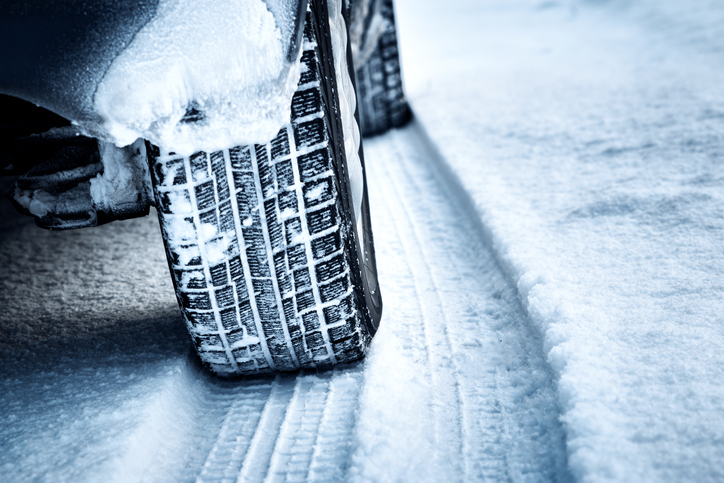 Car tires with snow in the tread.