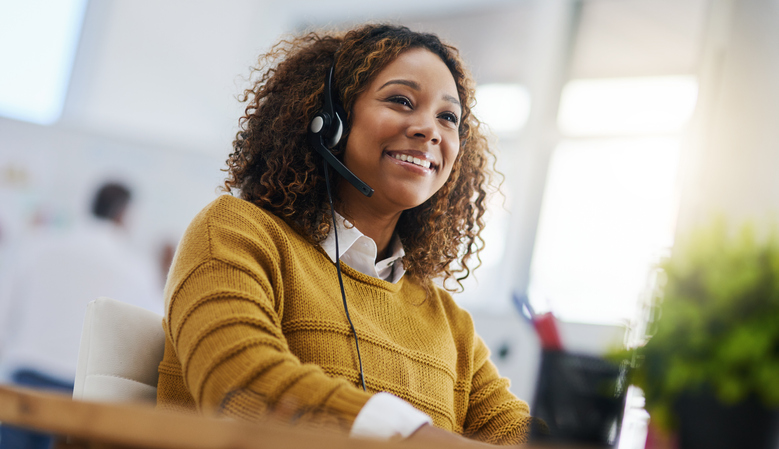 Woman wearing headset smiling.