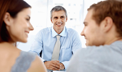 Insurance Agent talking to a couple.