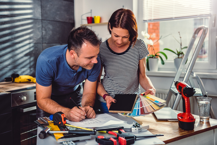 A couple planning a DIY project for their kitchen.