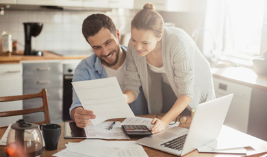 A man and woman looking over a document together.