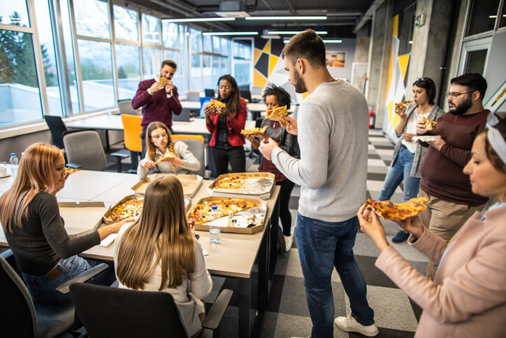 Employees enjoying a pizza in the office.
