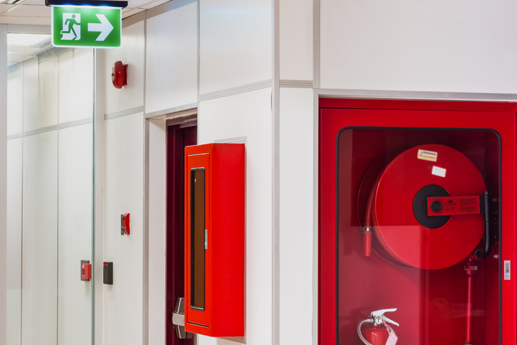 A fire extinguisher near an exit doorway.