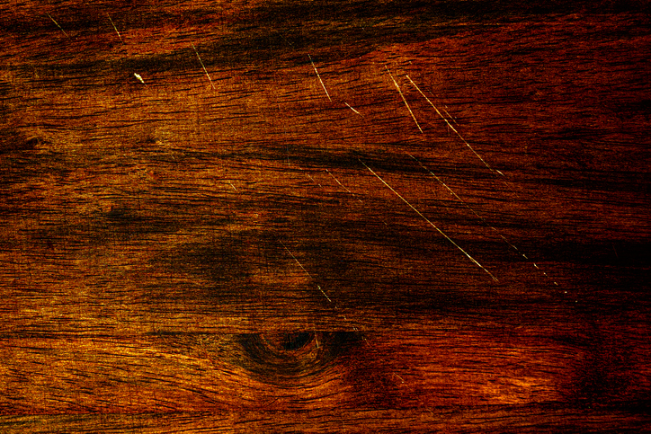 Section of a dark hardwood floor with a few scratches.