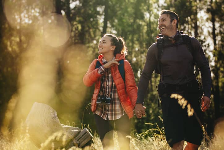 Couple hiking in a forest preserve.
