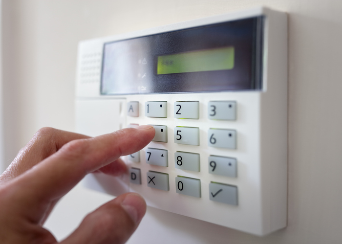 Business owner entering their office security code.
