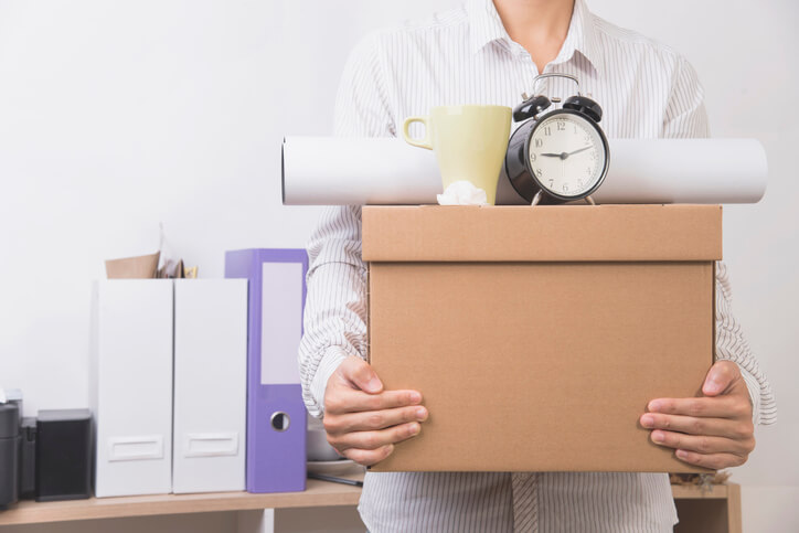 A working hold a box of their office things.