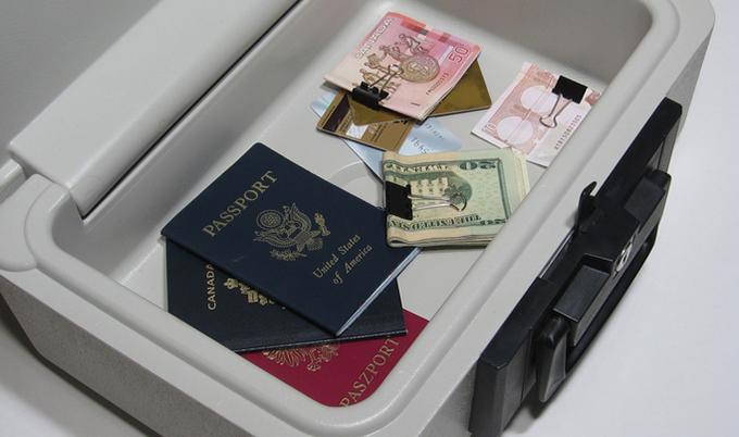 A lockbox open showing money and passports.