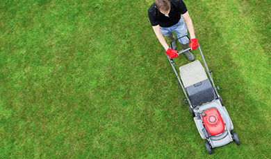Overhead view of a man mowing the grass.