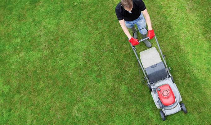 Overhead view of a man mowing the grass.