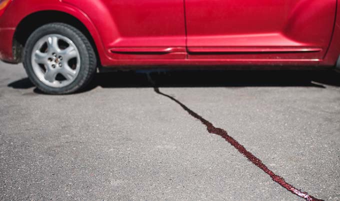 Oil streak on driveway coming from car.