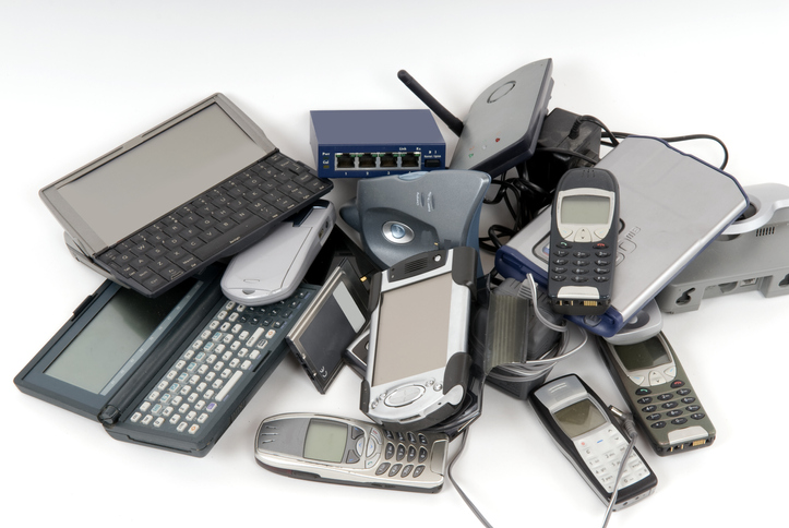 A pile of old mobile phones and other electronics.