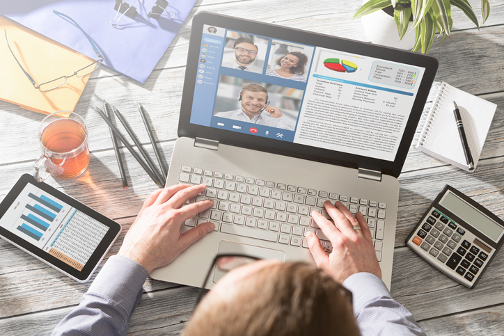 Man viewing his remote video conference meeting.