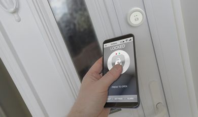 A person unlocking the door with their mobile phone.  