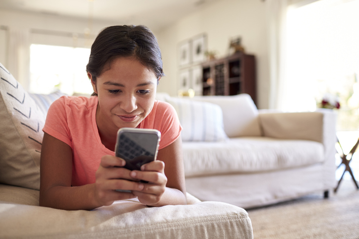 Group young students on their smartphones.