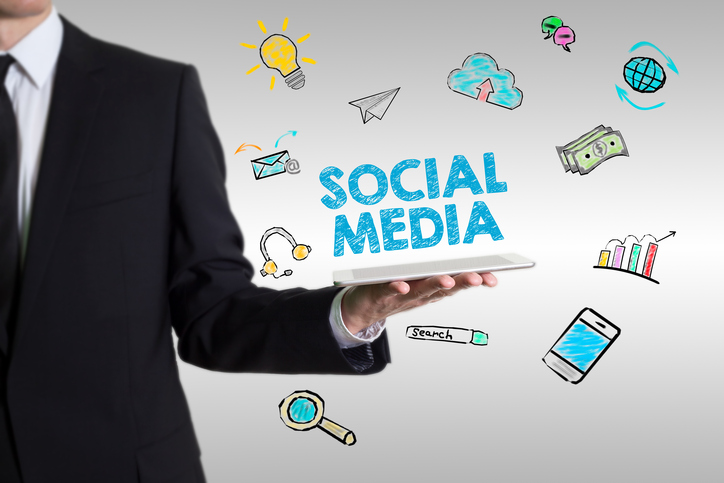 A manager holding up the social media in their hand.