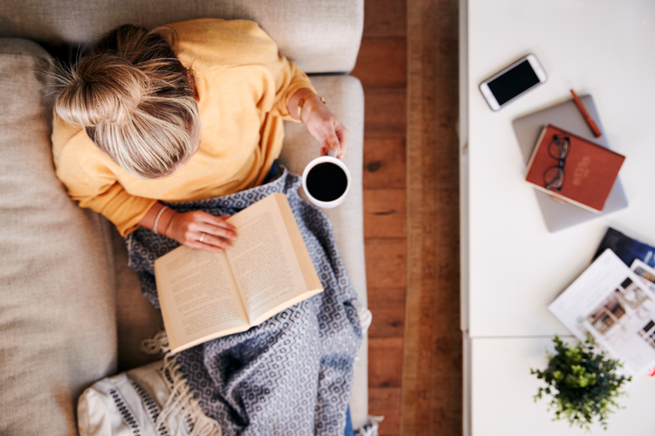 Woman on couch working. 