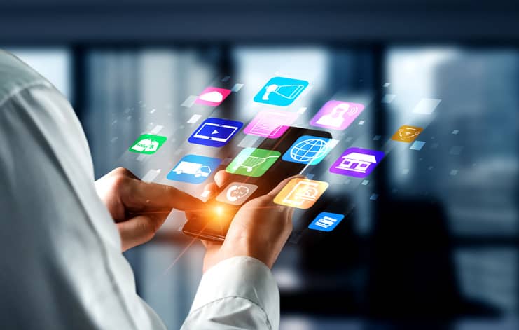 Man holding smartphone while the apps pop out of the phone. 