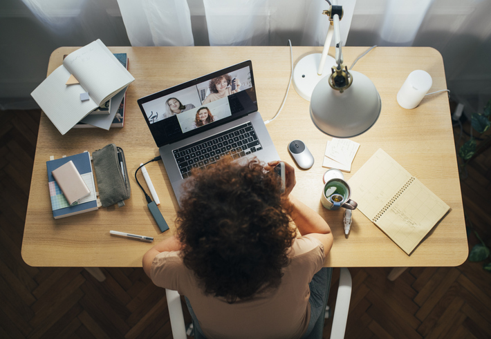 Overhead view of a woman on a zoom video chat.