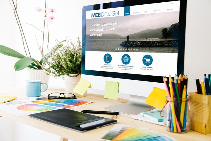 View of a monitor displaying a website design template.