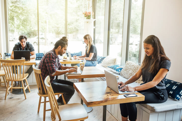 People in a cafe using their laptops.