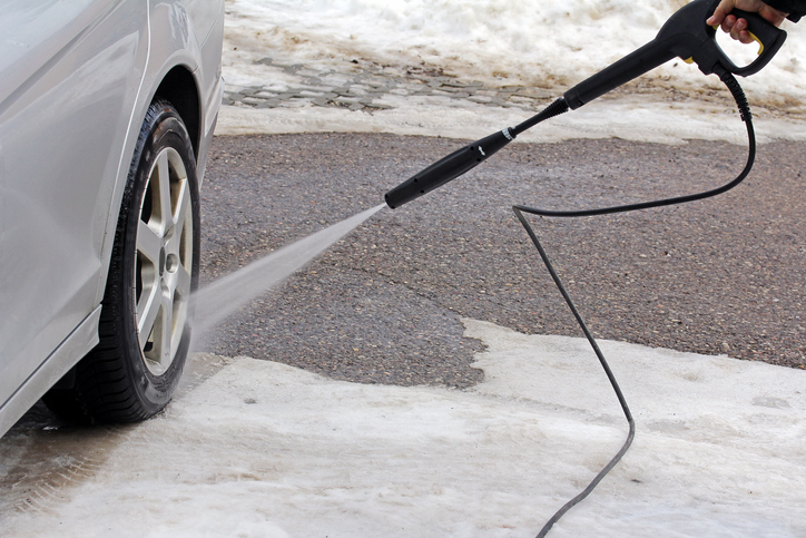 Hosing down the rear car tire. 