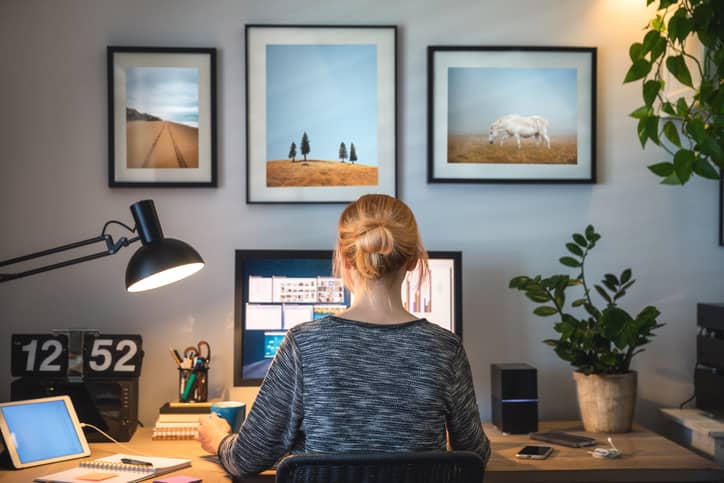 Woman facing her computer screen on home office desk.