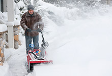Man using a snow blower. 